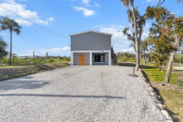 view of front of house with driveway and stairway