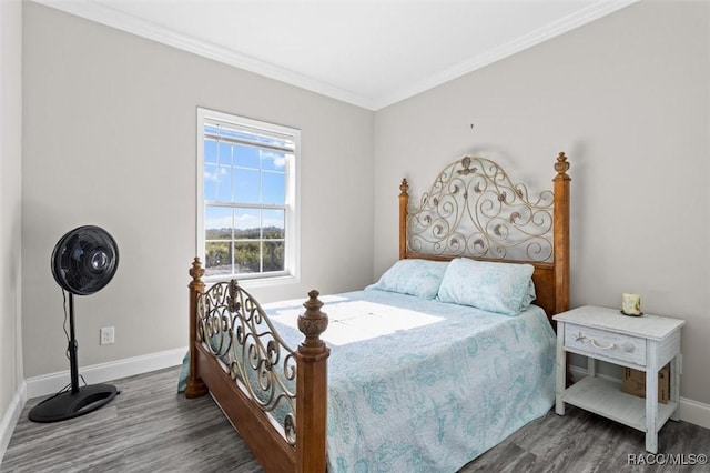 bedroom featuring ornamental molding, baseboards, and wood finished floors