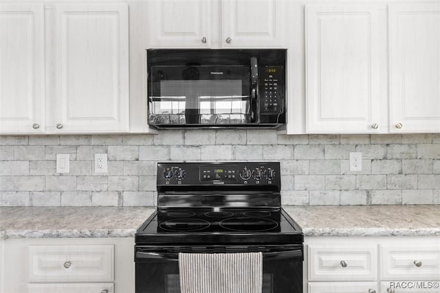 kitchen featuring black appliances, backsplash, and white cabinets