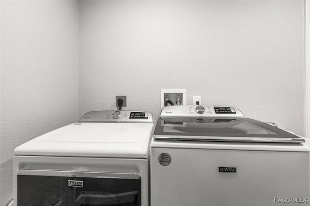 laundry area with separate washer and dryer