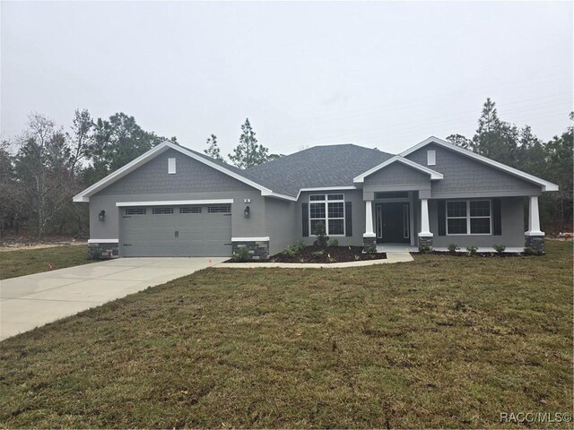 view of front facade with a garage and a front lawn