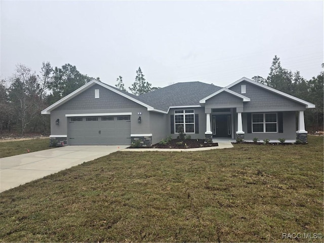 craftsman-style home featuring driveway, a garage, and a front yard