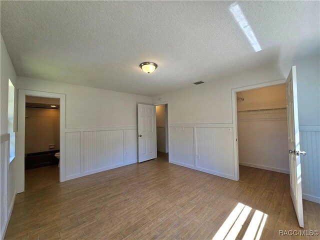 bathroom with hardwood / wood-style flooring, vanity, and toilet