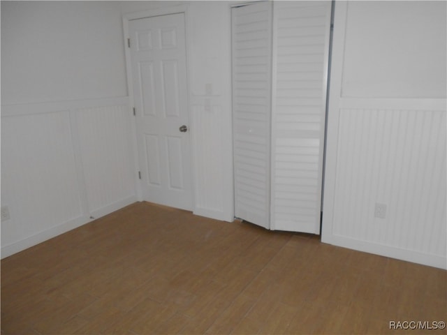 unfurnished bedroom with wood-type flooring