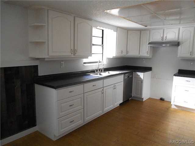 kitchen with white cabinets, sink, hardwood / wood-style flooring, dishwasher, and range hood