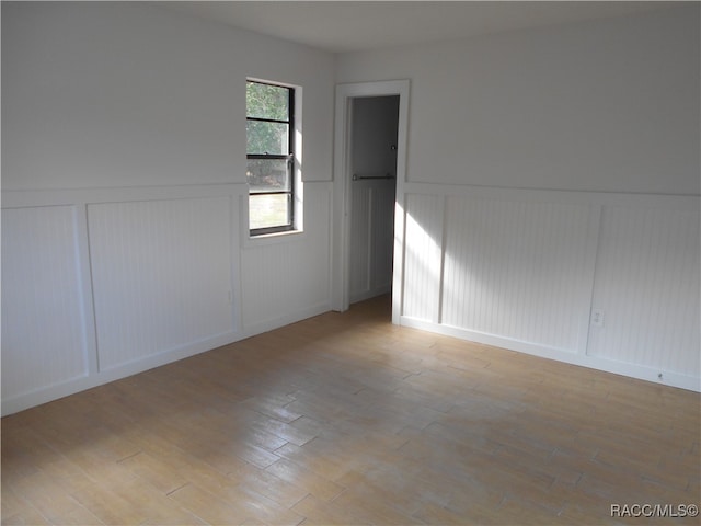 unfurnished room with light hardwood / wood-style flooring