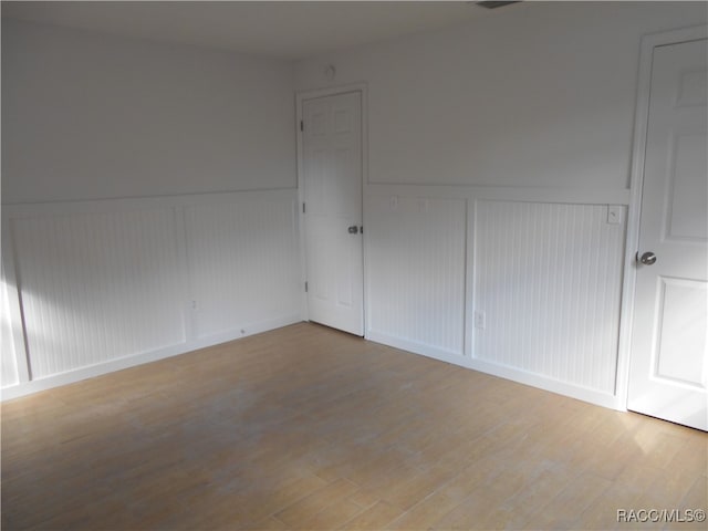 spare room with wood-type flooring