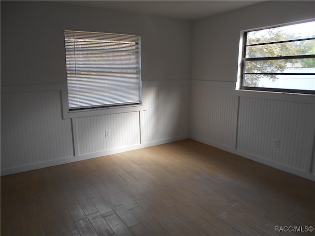 unfurnished room featuring hardwood / wood-style flooring