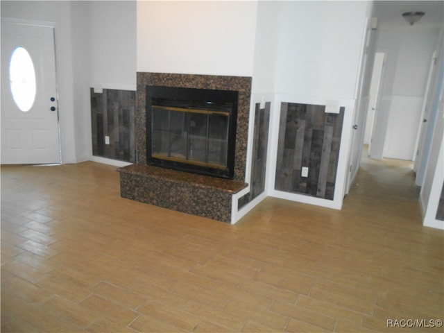 unfurnished living room featuring a fireplace and hardwood / wood-style floors