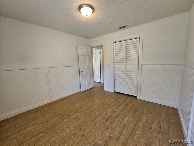 unfurnished room with wood-type flooring