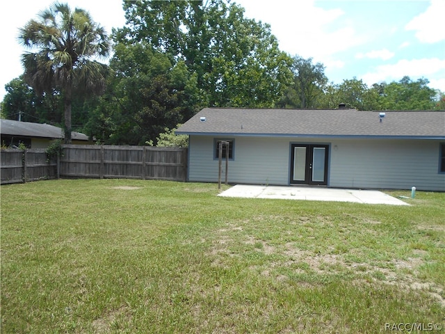 back of property featuring french doors, a yard, and a patio area