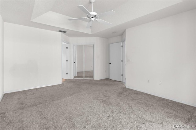 2739 N Brentwood Cir, Lecanto, FL 34461 - unfurnished room with carpet flooring, a ceiling fan, a tray ceiling, and baseboards