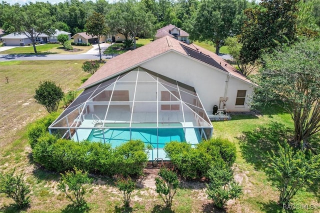 2739 N Brentwood Cir, Lecanto, FL 34461 - view of property exterior featuring stucco siding, a lawn, an outdoor pool, and a lanai