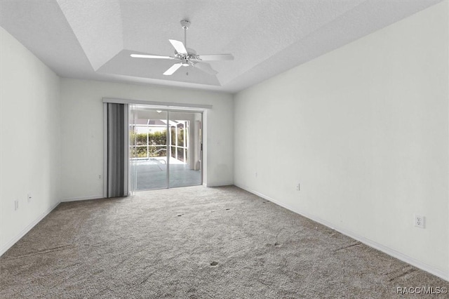 2739 N Brentwood Cir, Lecanto, FL 34461 - empty room featuring a raised ceiling, carpet, ceiling fan, baseboards, and a textured ceiling