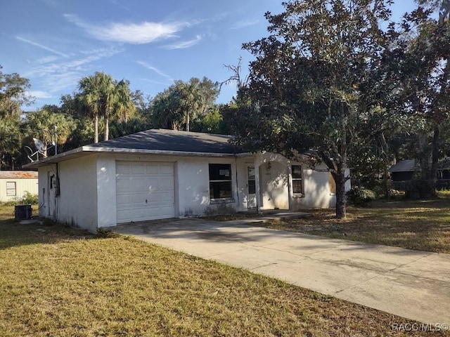 single story home featuring a front yard and a garage