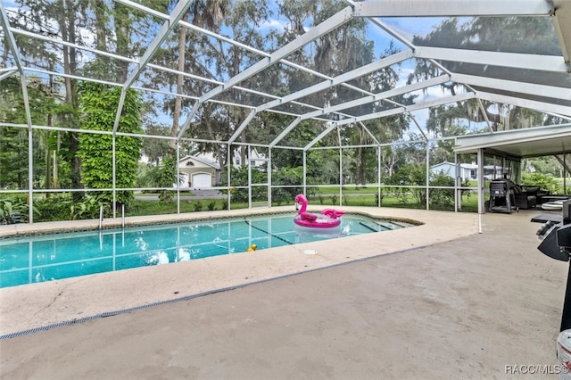 view of swimming pool with glass enclosure and a patio area