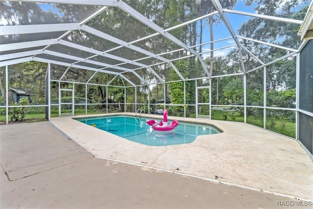 view of pool with a patio area and a lanai