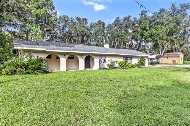 ranch-style house featuring a front lawn