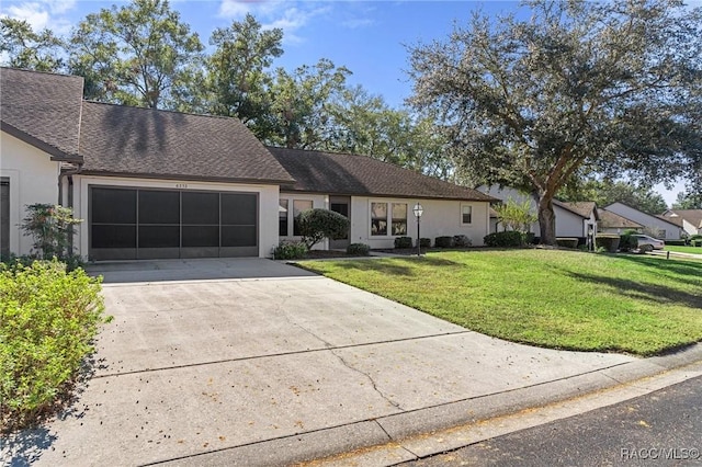 ranch-style home with a front yard and a garage