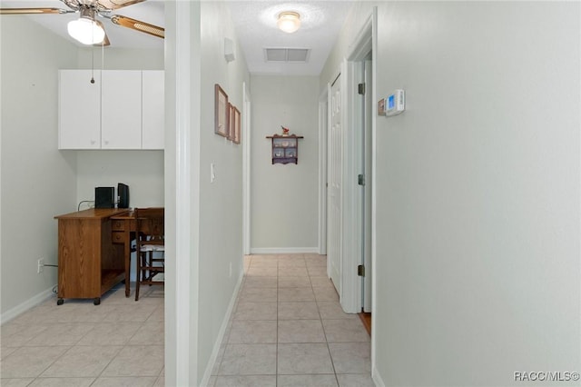 hall with light tile patterned floors