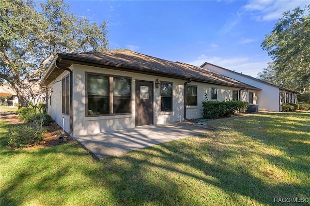 rear view of property with central AC, a yard, and a patio