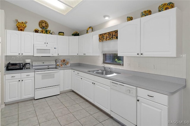 kitchen featuring white cabinetry, sink, light tile patterned flooring, and white appliances