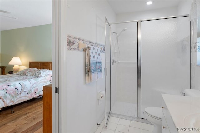 bathroom with vanity, wood-type flooring, an enclosed shower, and toilet