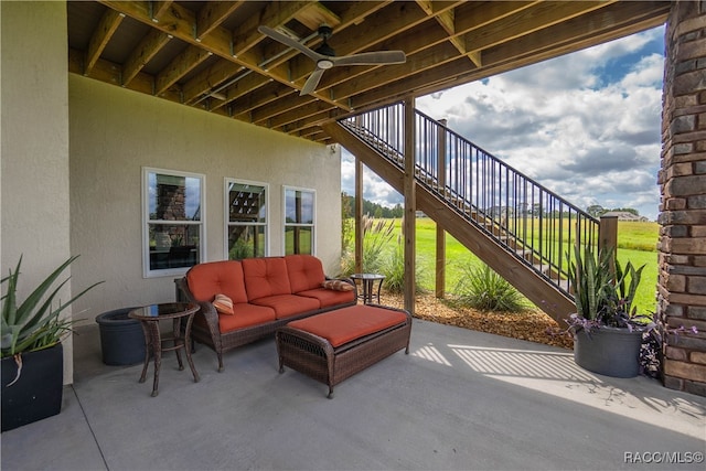 view of patio / terrace featuring ceiling fan, stairway, and outdoor lounge area