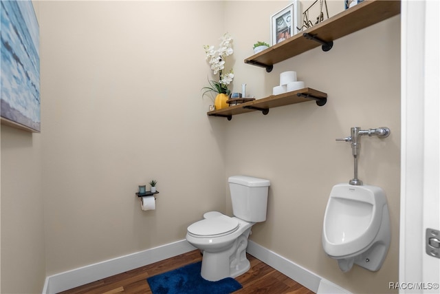 half bath with toilet, baseboards, and wood finished floors