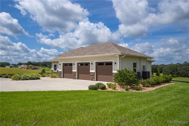 view of property exterior featuring central air condition unit, stone siding, concrete driveway, and a yard