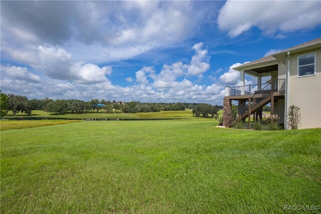 view of yard featuring stairway and a rural view