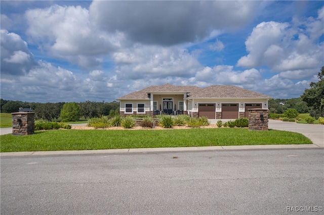 view of front facade with a garage, driveway, and a front yard