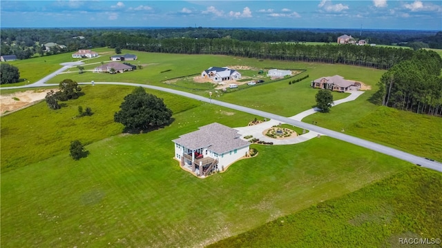 birds eye view of property with a rural view