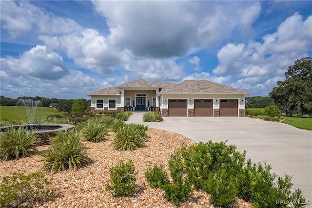 view of front of home featuring a garage and concrete driveway