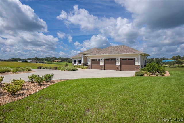 view of front of home featuring a front yard, driveway, and an attached garage