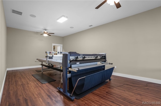 bedroom with ceiling fan, wood finished floors, visible vents, and baseboards