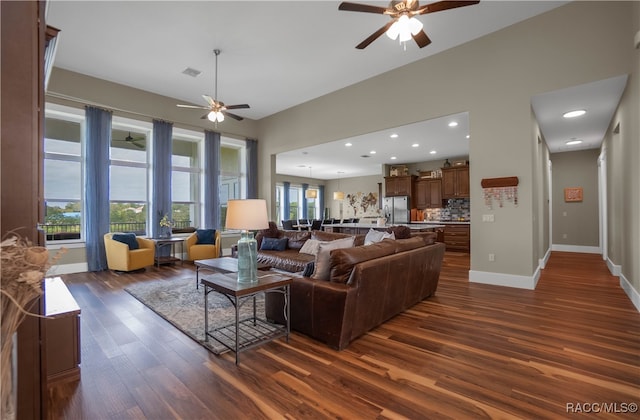 living area with ceiling fan, recessed lighting, visible vents, baseboards, and dark wood finished floors