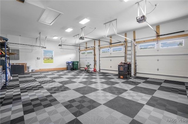 garage with a garage door opener and baseboards