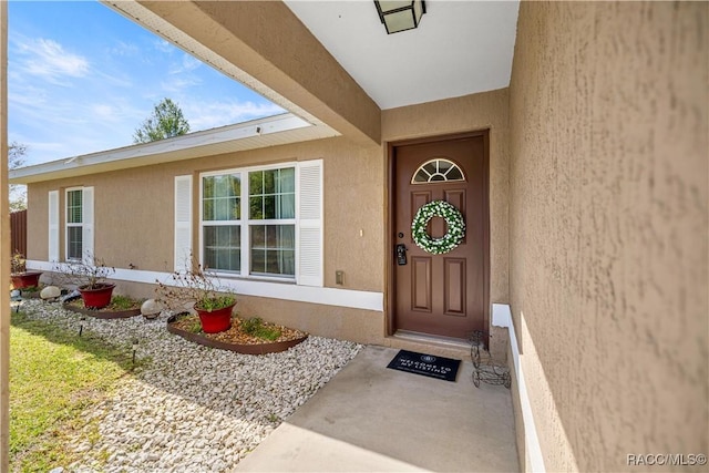 176 Juniper Loop Cir, Ocala, FL 34480 - doorway to property with stucco siding