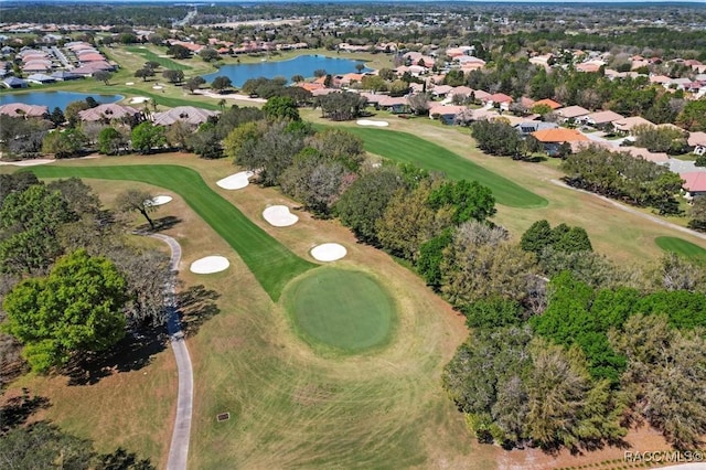 birds eye view of property featuring a residential view, a water view, and view of golf course
