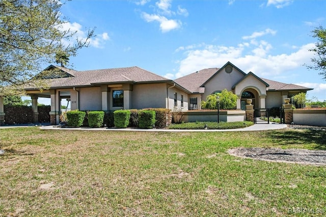 single story home featuring a gate, stucco siding, a fenced front yard, and a front yard