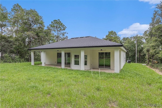 rear view of house featuring a patio, ceiling fan, and a yard