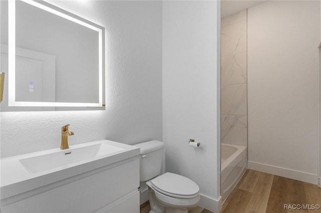 full bathroom featuring  shower combination, toilet, vanity, and wood-type flooring