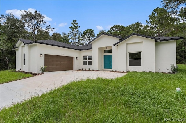 view of front of property featuring a garage and a front yard