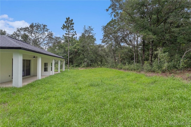 view of yard with a patio and ceiling fan