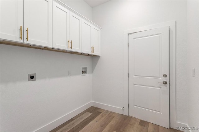 clothes washing area featuring cabinets, hookup for an electric dryer, hookup for a washing machine, and light hardwood / wood-style floors