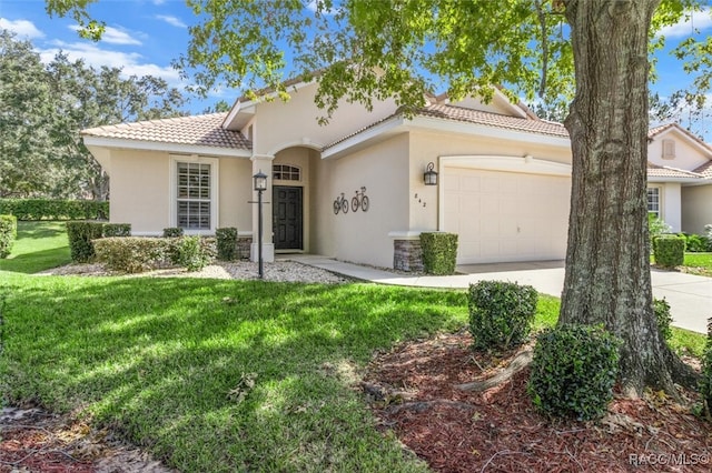 mediterranean / spanish home with a front lawn and a garage