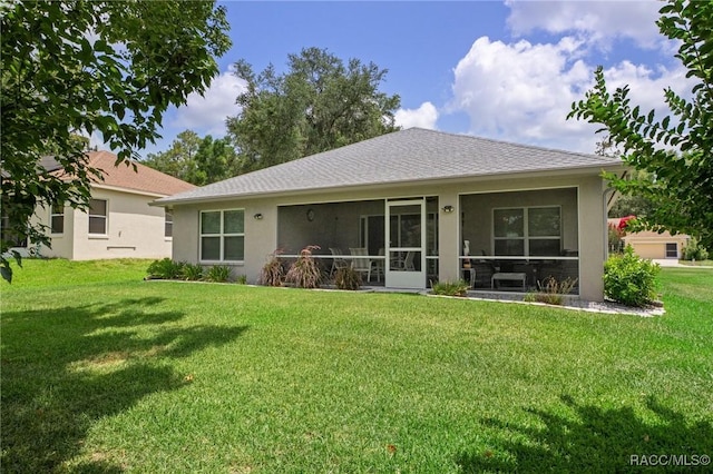 2880 N Folkestone Loop, Hernando, FL 34442 - rear view of house with stucco siding, a yard, and a shingled roof