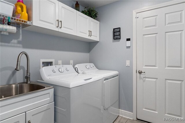2880 N Folkestone Loop, Hernando, FL 34442 - laundry area featuring independent washer and dryer, cabinet space, and light tile patterned floors