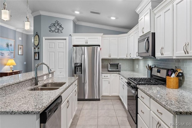 2880 N Folkestone Loop, Hernando, FL 34442 - kitchen featuring stainless steel appliances, ornamental molding, decorative backsplash, light tile patterned floors, and white cabinetry